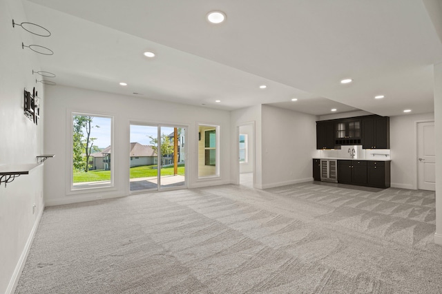 3001 Rivington Dr, Columbia, MO 65203 - unfurnished living room featuring light colored carpet, recessed lighting, and bar