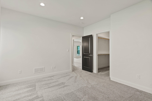 3001 Rivington Dr, Columbia, MO 65203 - unfurnished bedroom featuring carpet flooring, recessed lighting, and a walk in closet