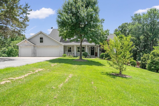 10550 E David Allen Rd, Columbia, MO 65201 - view of front facade featuring driveway, an attached garage, a front yard, and brick siding