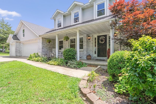 10550 E David Allen Rd, Columbia, MO 65201 - view of front facade with covered porch, brick siding, a front lawn, and driveway