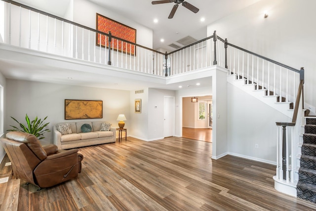 10550 E David Allen Rd, Columbia, MO 65201 - living room featuring a ceiling fan, stairway, wood finished floors, recessed lighting, and a towering ceiling