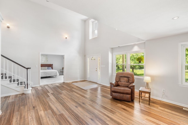 10550 E David Allen Rd, Columbia, MO 65201 - foyer featuring wood finished floors, a towering ceiling, and stairway