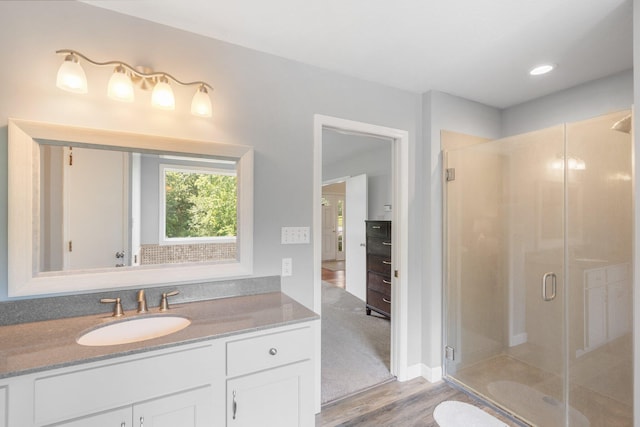 10550 E David Allen Rd, Columbia, MO 65201 - bathroom featuring wood finished floors, vanity, a stall shower, and recessed lighting