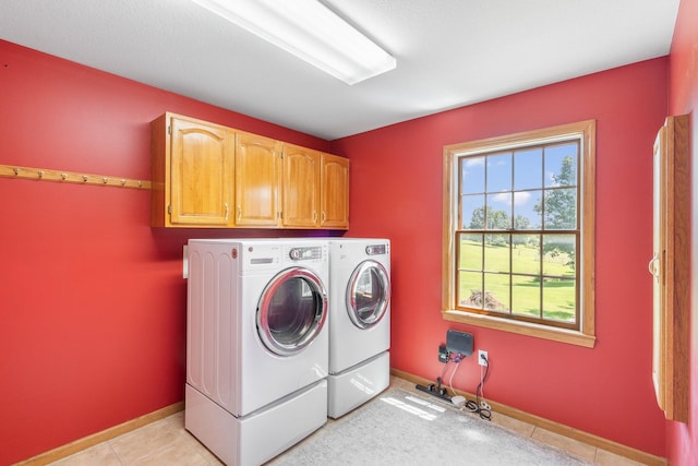 10550 E David Allen Rd, Columbia, MO 65201 - laundry room featuring separate washer and dryer, cabinet space, and light tile patterned flooring