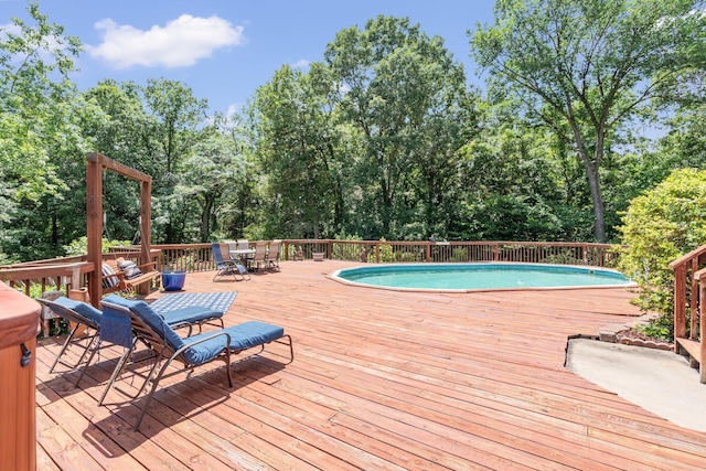 10550 E David Allen Rd, Columbia, MO 65201 - view of swimming pool featuring outdoor dining space, a wooden deck, and view of scattered trees