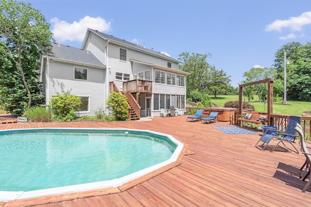 10550 E David Allen Rd, Columbia, MO 65201 - swimming pool featuring a sunroom, a wooden deck, a covered hot tub, and stairs