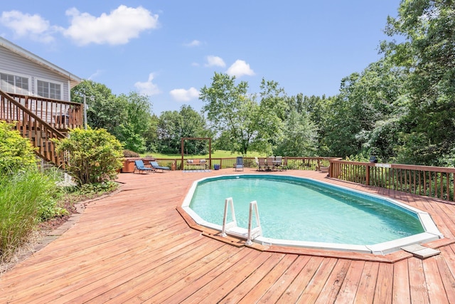 10550 E David Allen Rd, Columbia, MO 65201 - view of swimming pool featuring a wooden deck, view of scattered trees, and outdoor dining area