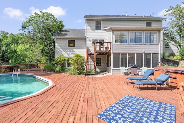 10550 E David Allen Rd, Columbia, MO 65201 - back of house featuring a hot tub, a sunroom, a deck, an outdoor pool, and stairway
