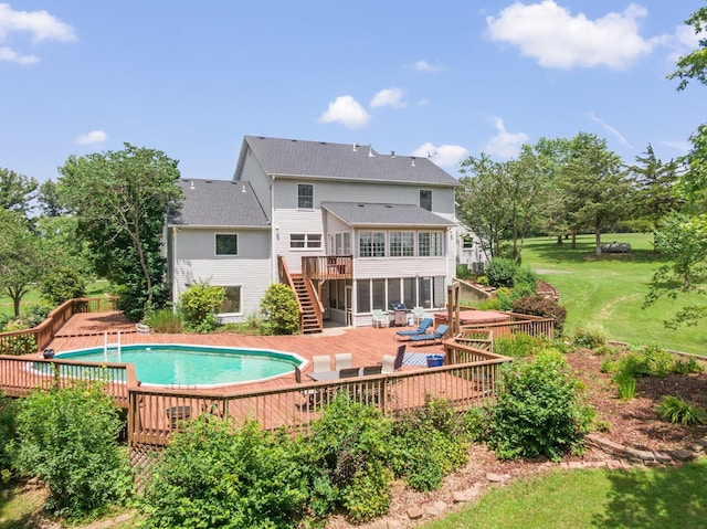 10550 E David Allen Rd, Columbia, MO 65201 - back of house featuring a wooden deck, stairway, a sunroom, an outdoor pool, and a patio