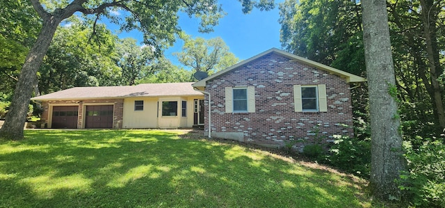 2716 Shagbark Cir, Jefferson City, MO 65109 - back of house with brick siding, an attached garage, and a yard