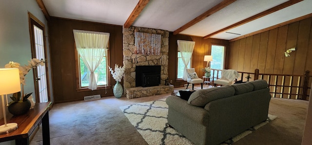 2716 Shagbark Cir, Jefferson City, MO 65109 - carpeted living room with plenty of natural light, a stone fireplace, and wooden walls