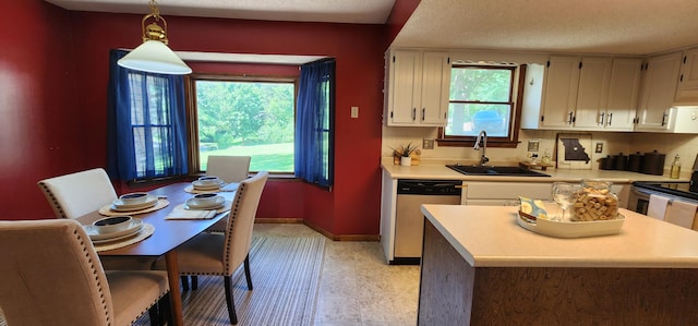 2716 Shagbark Cir, Jefferson City, MO 65109 - kitchen with stainless steel appliances, light countertops, hanging light fixtures, and white cabinets