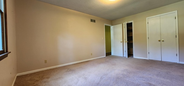2716 Shagbark Cir, Jefferson City, MO 65109 - unfurnished bedroom featuring carpet and a textured ceiling