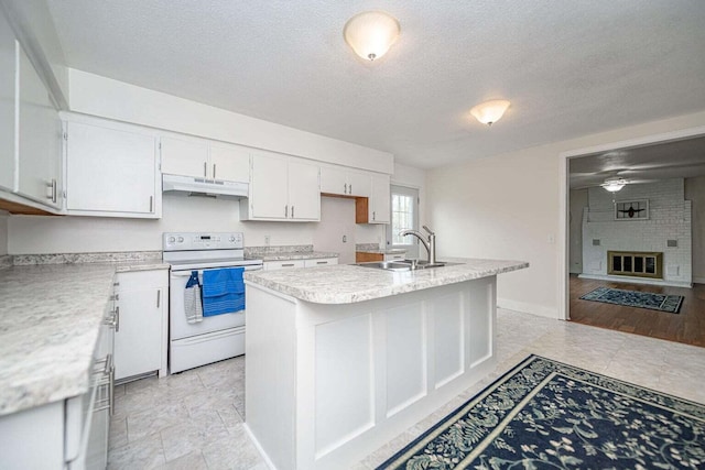 2130 E 163, Columbia, MO 65201 - kitchen featuring white electric stove, under cabinet range hood, light countertops, a textured ceiling, and white cabinetry