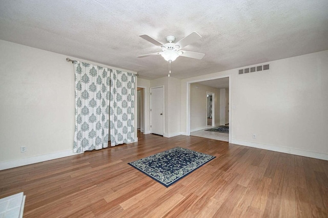 2130 E 163, Columbia, MO 65201 - unfurnished room with ceiling fan, wood finished floors, and a textured ceiling