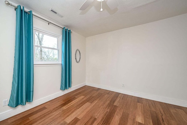 2130 E 163, Columbia, MO 65201 - empty room featuring wood finished floors, ceiling fan, and a textured ceiling