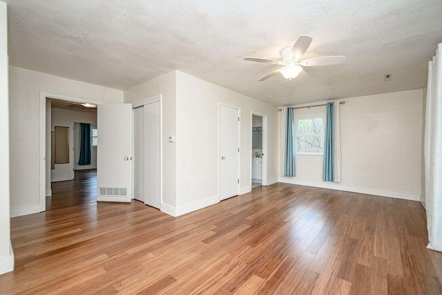 2130 E 163, Columbia, MO 65201 - empty room with a ceiling fan, light wood-style flooring, and a textured ceiling