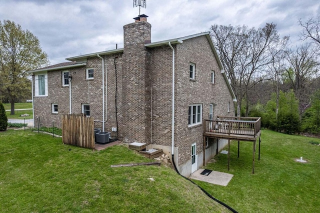 2130 E 163, Columbia, MO 65201 - rear view of house featuring a wooden deck, brick siding, a chimney, and a yard