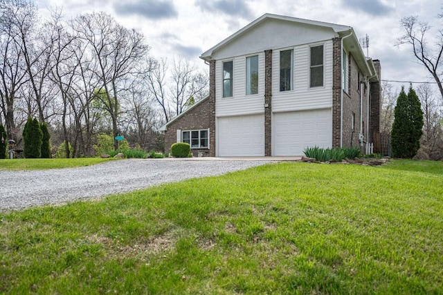 2130 E 163, Columbia, MO 65201 - view of property exterior with brick siding, gravel driveway, a garage, and a lawn