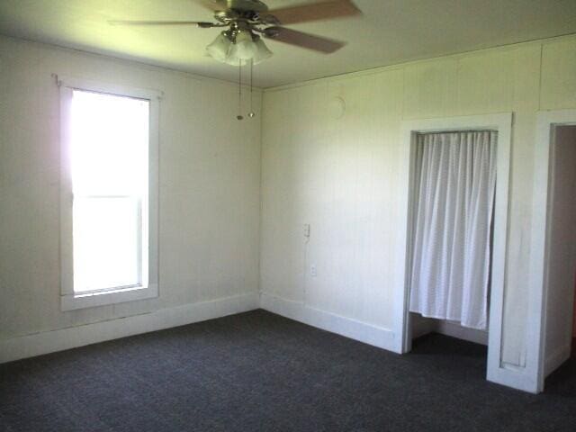17750 N Rte Z, Centralia, MO 65240 - unfurnished room featuring dark carpet and ceiling fan
