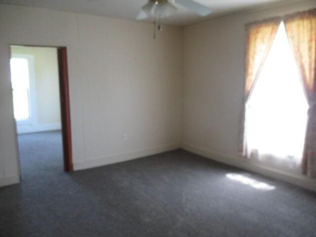17750 N Rte Z, Centralia, MO 65240 - unfurnished room with ceiling fan, dark carpet, and plenty of natural light