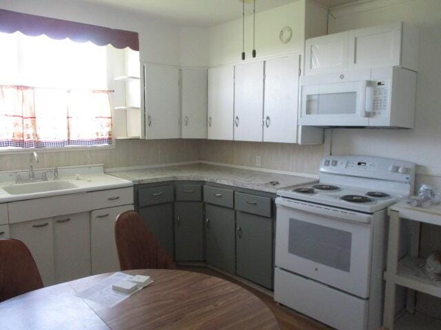 17750 N Rte Z, Centralia, MO 65240 - kitchen featuring white appliances, light countertops, and gray cabinets