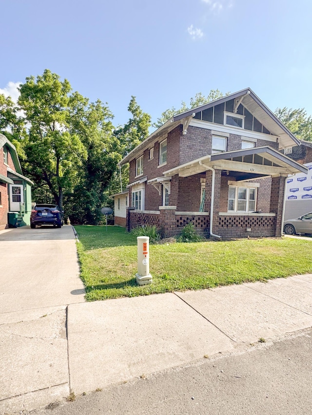 632 W Logan St, Moberly, MO 65270 - view of side of property with brick siding, a yard, and driveway