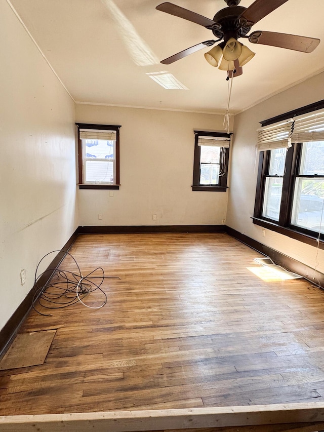 632 W Logan St, Moberly, MO 65270 - spare room featuring light wood-type flooring, ceiling fan, and crown molding