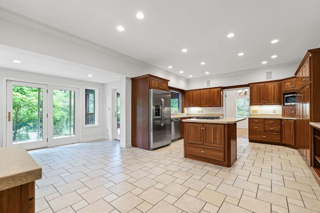 450 W Covered Bridge Rd, Columbia, MO 65203 - kitchen with appliances with stainless steel finishes, light countertops, ornamental molding, a center island, and plenty of natural light