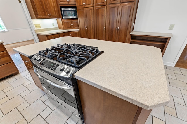 450 W Covered Bridge Rd, Columbia, MO 65203 - kitchen featuring stainless steel appliances, light countertops, and brown cabinetry