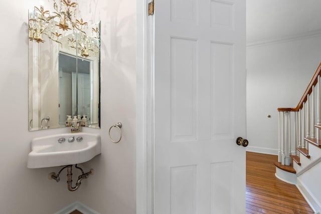 450 W Covered Bridge Rd, Columbia, MO 65203 - bathroom featuring hardwood / wood-style flooring, ornamental molding, and a chandelier