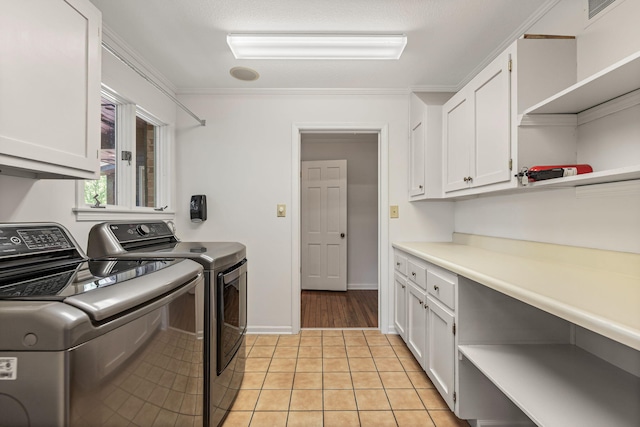 450 W Covered Bridge Rd, Columbia, MO 65203 - washroom with washing machine and clothes dryer, cabinet space, light tile patterned floors, and ornamental molding