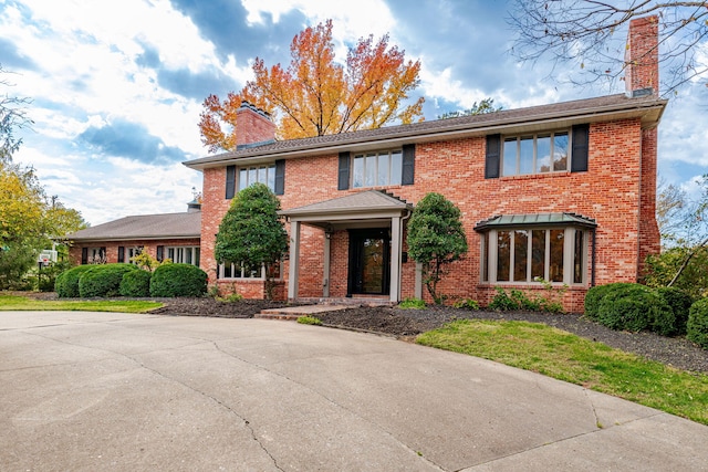 450 W Covered Bridge Rd, Columbia, MO 65203 - colonial house featuring a chimney and brick siding