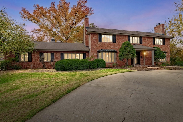 450 W Covered Bridge Rd, Columbia, MO 65203 - view of front of property with a chimney, brick siding, and a front lawn