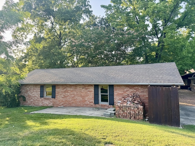 450 W Covered Bridge Rd, Columbia, MO 65203 - view of front of home with a shingled roof, brick siding, a front lawn, and a patio