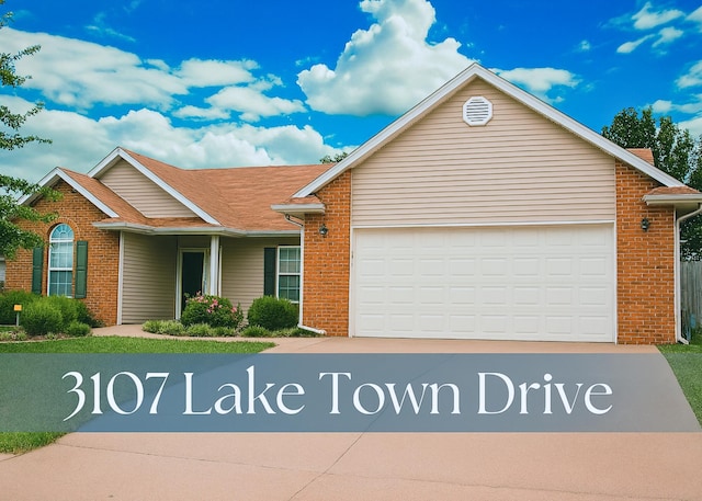 3107 Lake Town Dr, Columbia, MO 65203 - view of front facade featuring brick siding, concrete driveway, an attached garage, and roof with shingles