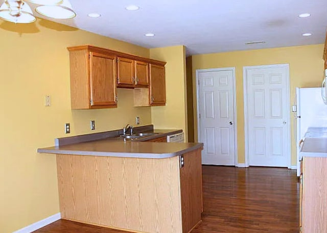 3107 Lake Town Dr, Columbia, MO 65203 - kitchen with dark wood-style flooring, a peninsula, recessed lighting, brown cabinetry, and dishwashing machine
