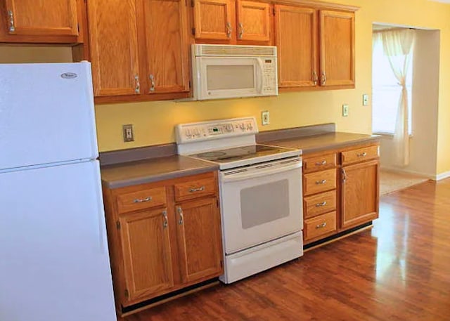 3107 Lake Town Dr, Columbia, MO 65203 - kitchen with white appliances, dark wood-type flooring, brown cabinets, and dark countertops