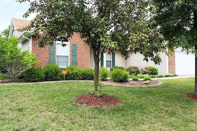 3107 Lake Town Dr, Columbia, MO 65203 - obstructed view of property with a front yard, brick siding, and an attached garage