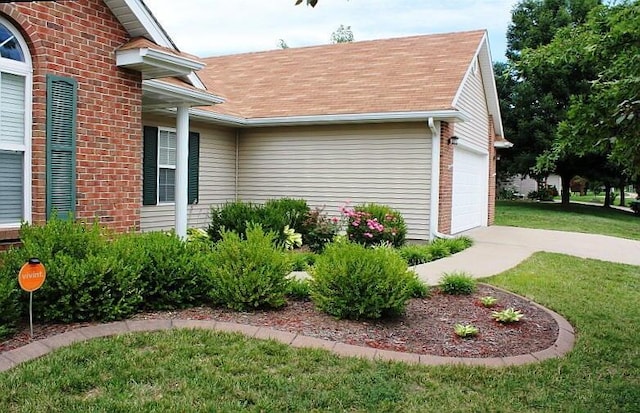 3107 Lake Town Dr, Columbia, MO 65203 - view of property exterior featuring a lawn, brick siding, an attached garage, and roof with shingles
