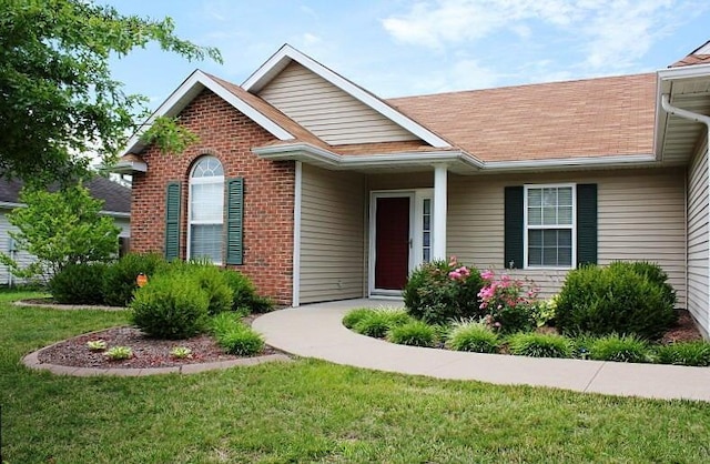 3107 Lake Town Dr, Columbia, MO 65203 - view of front of home featuring brick siding, a front yard, and a shingled roof