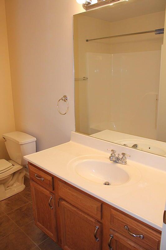 3107 Lake Town Dr, Columbia, MO 65203 - full bath featuring vanity, tile patterned floors, and a shower