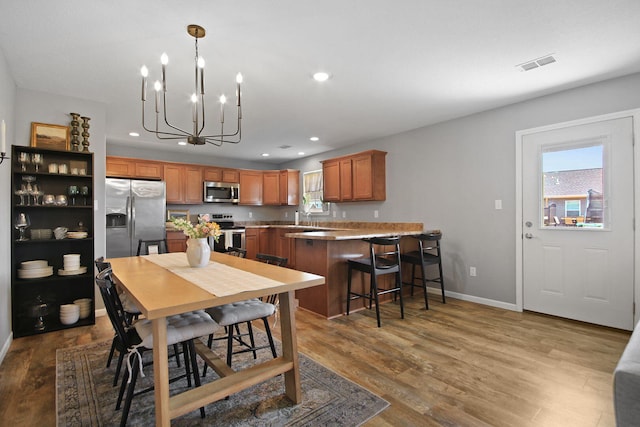925 Kelli Ct, Centralia, MO 65240 - dining room with recessed lighting, plenty of natural light, wood finished floors, and a chandelier