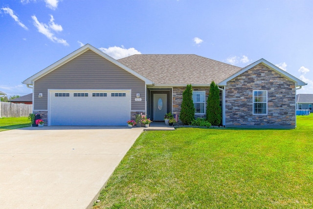 925 Kelli Ct, Centralia, MO 65240 - view of front of home with an attached garage, stone siding, driveway, and a shingled roof