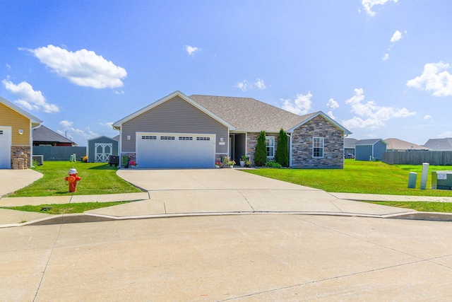 925 Kelli Ct, Centralia, MO 65240 - view of front of home featuring stone siding, a garage, concrete driveway, and a shed