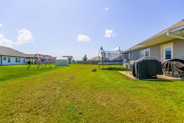 925 Kelli Ct, Centralia, MO 65240 - view of yard featuring a trampoline, a shed, and a playground