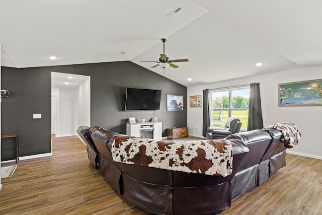 506 Addie Ln, Centralia, MO 65240 - living area featuring wood finished floors, a ceiling fan, vaulted ceiling, a brick fireplace, and recessed lighting