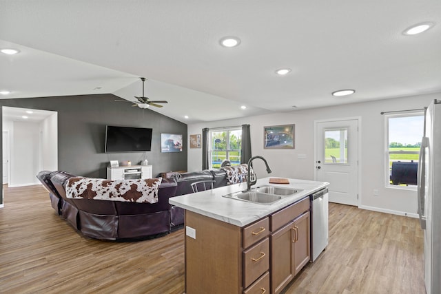 506 Addie Ln, Centralia, MO 65240 - kitchen featuring stainless steel dishwasher, light wood-style floors, lofted ceiling, light countertops, and freestanding refrigerator