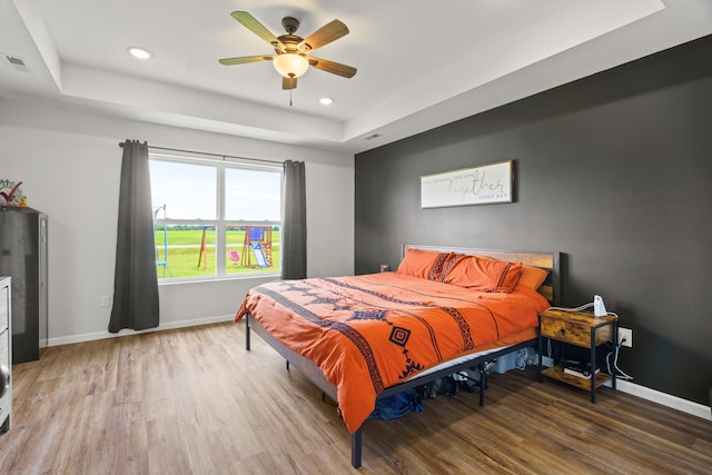 506 Addie Ln, Centralia, MO 65240 - bedroom with a raised ceiling, wood finished floors, recessed lighting, and a ceiling fan
