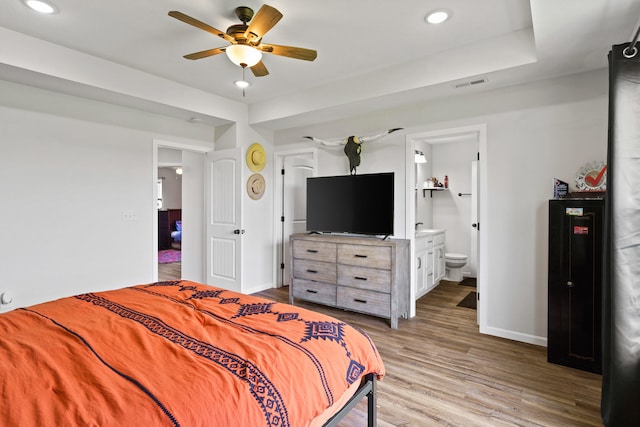 506 Addie Ln, Centralia, MO 65240 - bedroom featuring wood finished floors, recessed lighting, ensuite bathroom, and a ceiling fan